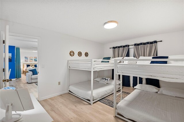 bedroom with wood finished floors and baseboards