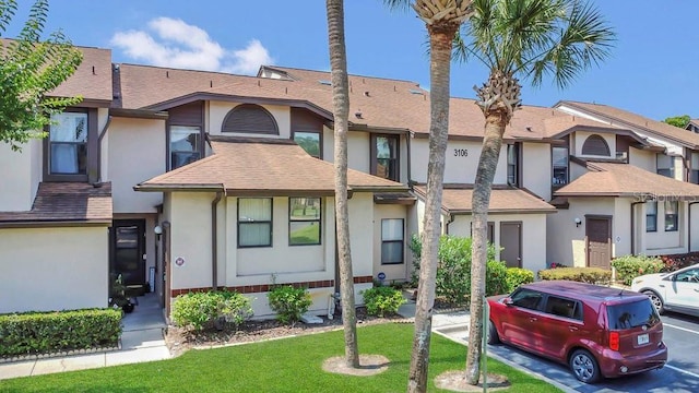 3106 S Semoran Blvd Unit P-2, Orlando, FL 32822 - multi unit property with stucco siding, a front yard, and a shingled roof