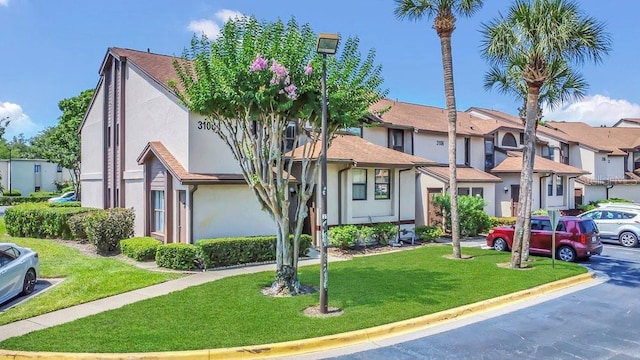 3106 S Semoran Blvd Unit P-2, Orlando, FL 32822 - multi unit property with stucco siding, a residential view, and a front lawn