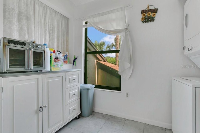 3106 S Semoran Blvd Unit P-2, Orlando, FL 32822 - bathroom with stacked washer and clothes dryer, baseboards, and tile patterned flooring