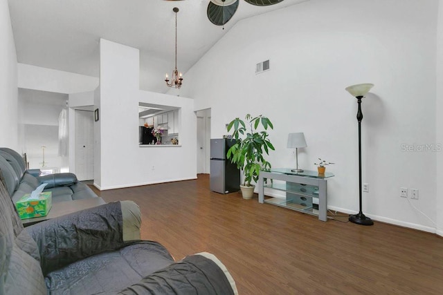3106 S Semoran Blvd Unit P-2, Orlando, FL 32822 - living area with high vaulted ceiling, wood finished floors, baseboards, a ceiling fan, and a chandelier