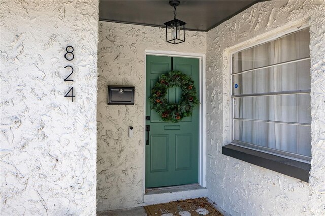 view of exterior entry with stucco siding
