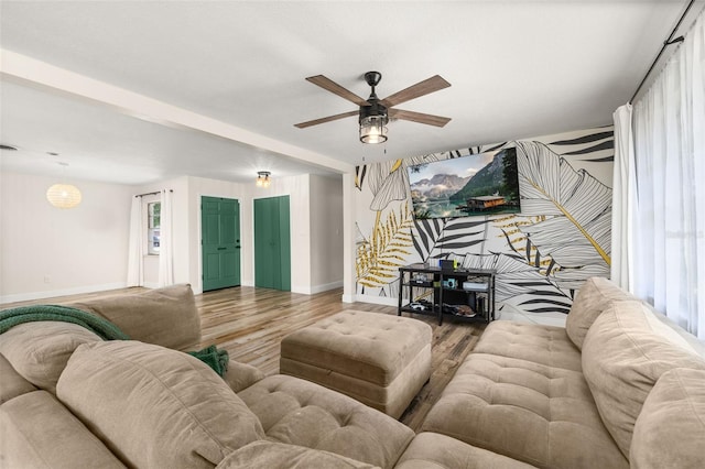 living room featuring ceiling fan, wood finished floors, and baseboards