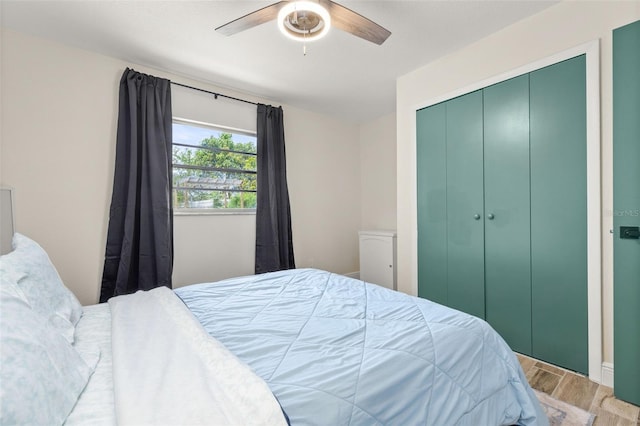 bedroom with wood finished floors, a ceiling fan, and a closet