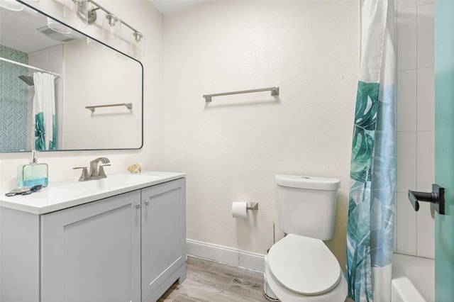 full bathroom featuring toilet, vanity, and baseboards