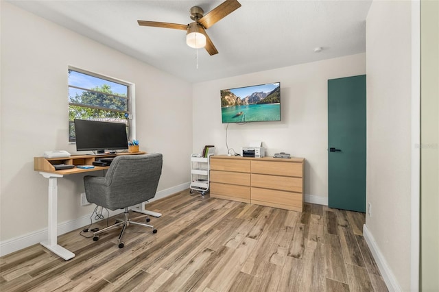 office with a ceiling fan, wood finished floors, and baseboards