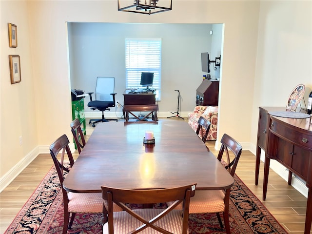 1644 Hibiscus Ave, Winter Park, FL 32789 - dining space with a chandelier, light wood-style flooring, and baseboards