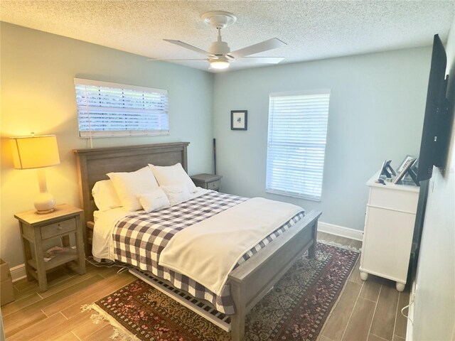 1644 Hibiscus Ave, Winter Park, FL 32789 - bedroom with ceiling fan, multiple windows, wood finished floors, and a textured ceiling