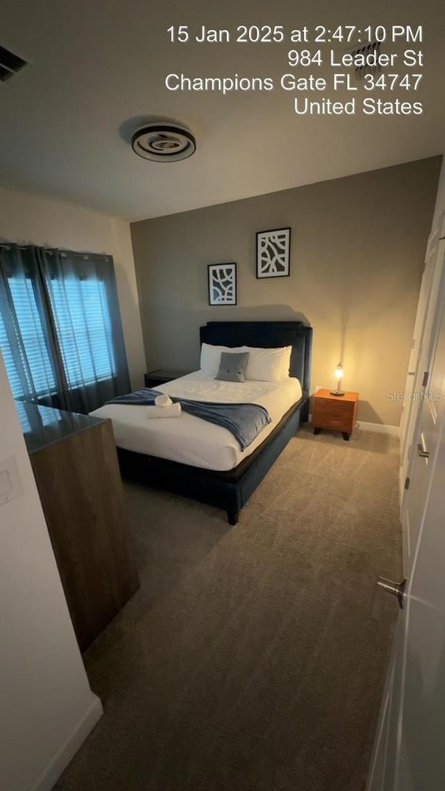 bedroom with visible vents, baseboards, and carpet floors