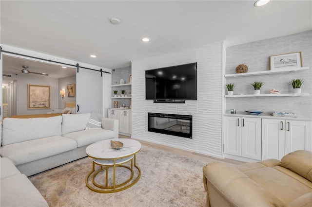 4139 S Atlantic Ave Unit B707, New Smyrna Beach, FL 32169 - living area featuring built in features, a large fireplace, recessed lighting, and a barn door