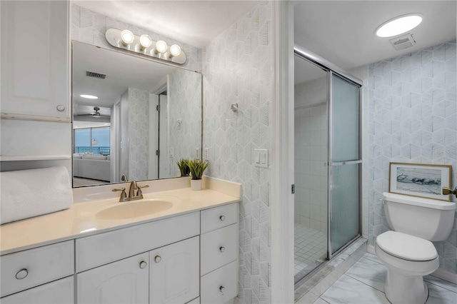 4139 S Atlantic Ave Unit B707, New Smyrna Beach, FL 32169 - bathroom with vanity, a stall shower, toilet, and visible vents