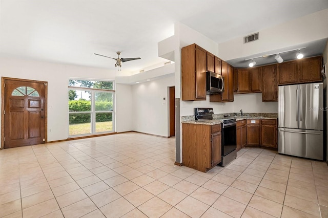6021 Navajo Way, Orlando, FL 32807 - kitchen with ceiling fan, visible vents, stainless steel appliances, light countertops, and open floor plan