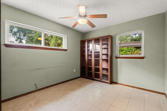 6021 Navajo Way, Orlando, FL 32807 - empty room with baseboards, a ceiling fan, and a textured ceiling