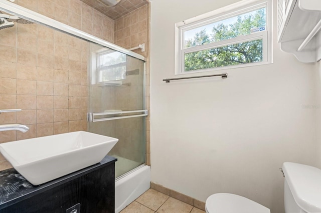 6021 Navajo Way, Orlando, FL 32807 - full bath featuring tile patterned floors, a healthy amount of sunlight, toilet, and combined bath / shower with glass door