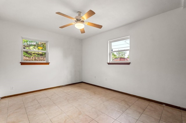 6021 Navajo Way, Orlando, FL 32807 - spare room with a ceiling fan, baseboards, and a healthy amount of sunlight