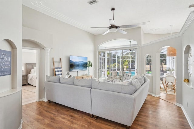 336 Plantation Club Dr, Debary, FL 32713 - living room featuring arched walkways, a ceiling fan, wood finished floors, and visible vents