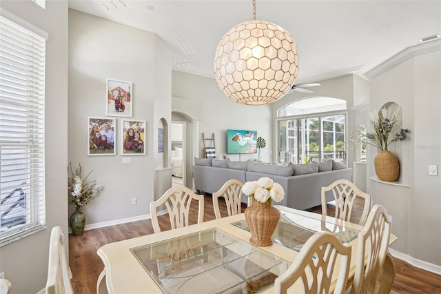336 Plantation Club Dr, Debary, FL 32713 - dining room featuring ornamental molding, wood finished floors, baseboards, ceiling fan, and arched walkways