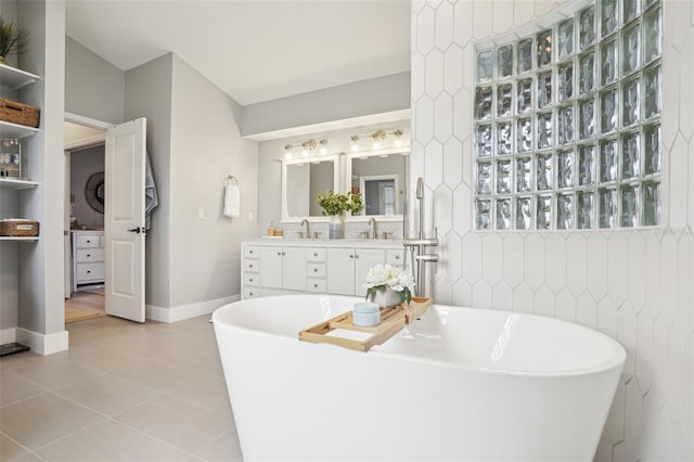336 Plantation Club Dr, Debary, FL 32713 - bathroom featuring a freestanding bath, tile walls, tile patterned flooring, vanity, and baseboards