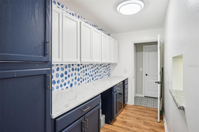 336 Plantation Club Dr, Debary, FL 32713 - laundry room with wine cooler, baseboards, and light wood-type flooring
