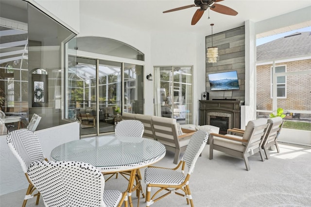 336 Plantation Club Dr, Debary, FL 32713 - sunroom featuring outdoor dining area, a ceiling fan, and a glass covered fireplace