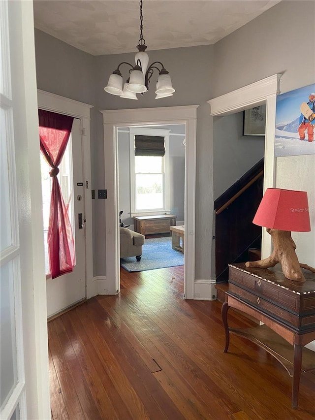 209 E 4th St, Sanford, FL 32771 - corridor featuring a chandelier, hardwood / wood-style flooring, and stairway