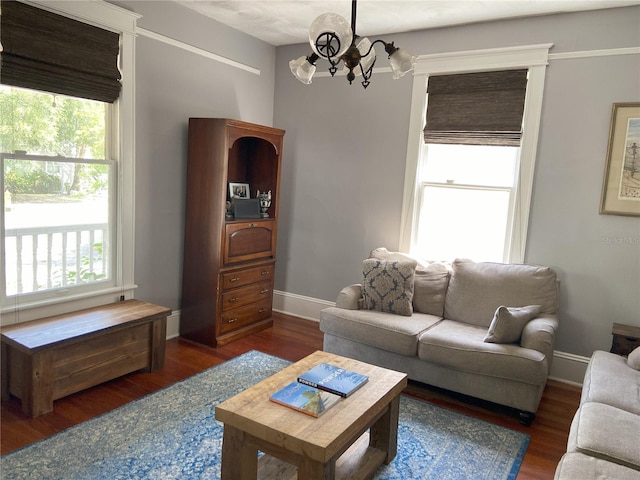 209 E 4th St, Sanford, FL 32771 - living room featuring baseboards, a chandelier, and wood finished floors