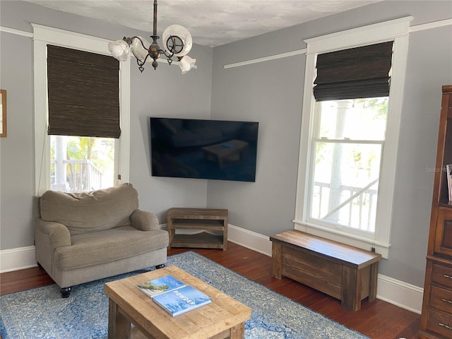 209 E 4th St, Sanford, FL 32771 - living room with an inviting chandelier, baseboards, and wood finished floors