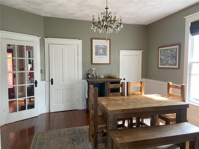 209 E 4th St, Sanford, FL 32771 - dining room with a wainscoted wall, wood-type flooring, and a notable chandelier