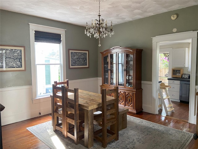 209 E 4th St, Sanford, FL 32771 - dining room featuring wainscoting, a notable chandelier, wood finished floors, and a wealth of natural light