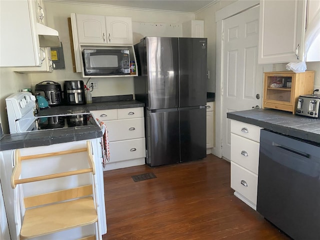 209 E 4th St, Sanford, FL 32771 - kitchen featuring white electric range oven, black microwave, freestanding refrigerator, white cabinetry, and dishwashing machine