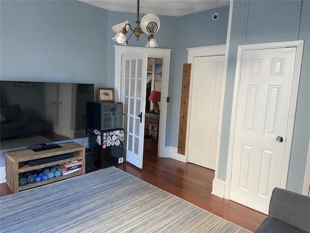 209 E 4th St, Sanford, FL 32771 - interior space with baseboards, an inviting chandelier, dark wood-style floors, and french doors