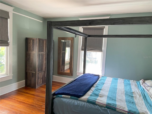 209 E 4th St, Sanford, FL 32771 - bedroom with baseboards and wood finished floors
