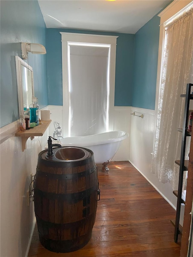 209 E 4th St, Sanford, FL 32771 - bathroom with wood-type flooring, wainscoting, and vanity