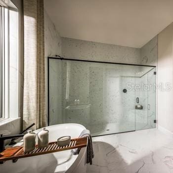 9429 Golden Laurel Ln, Orlando, FL 32827 - bathroom with marble finish flooring, a marble finish shower, and a freestanding bath