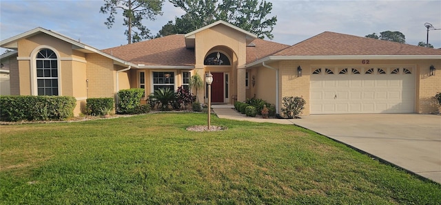 62 Barkley Ln, Palm Coast, FL 32137 - view of front of property featuring concrete driveway, a garage, a front yard, brick siding, and a shingled roof