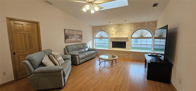 62 Barkley Ln, Palm Coast, FL 32137 - living area with wood finished floors, ceiling fan, lofted ceiling, and a stone fireplace