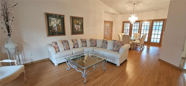 62 Barkley Ln, Palm Coast, FL 32137 - living room with light wood-style flooring, baseboards, lofted ceiling, and a chandelier