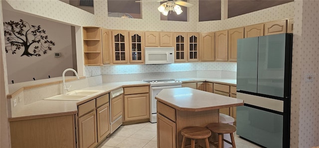 62 Barkley Ln, Palm Coast, FL 32137 - kitchen with white appliances, wallpapered walls, a sink, light brown cabinetry, and light countertops