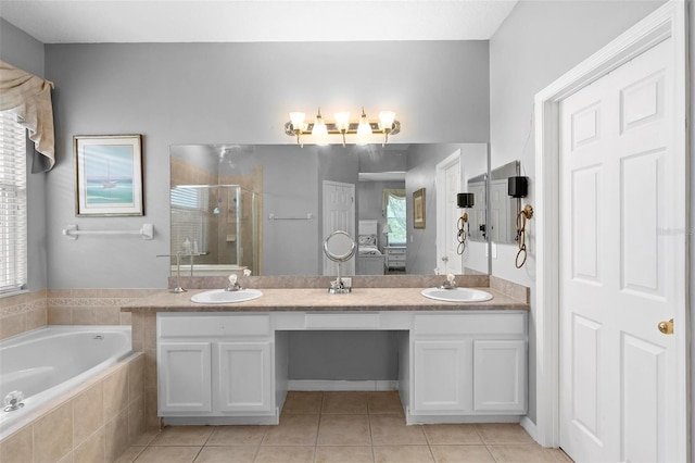 full bathroom with tile patterned flooring, a sink, and a shower stall