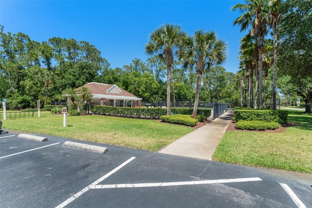4306 Pebblestone Ct, Orlando, FL 32826 - uncovered parking lot with view of wooded area