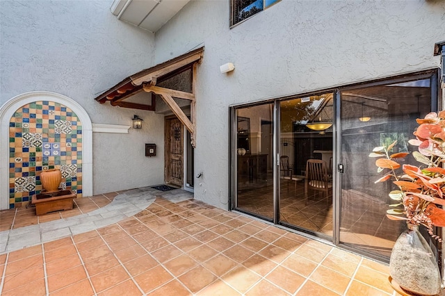 doorway to property featuring stucco siding