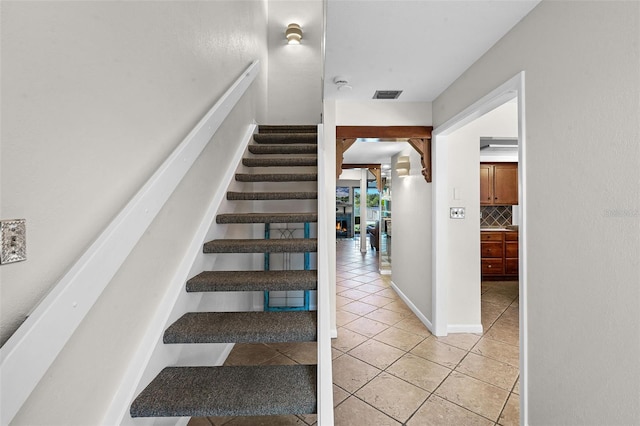 stairs featuring tile patterned floors and visible vents