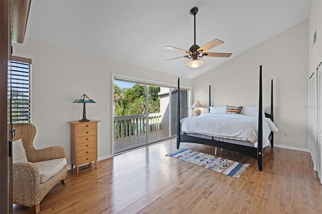 bedroom with baseboards, access to exterior, wood finished floors, and lofted ceiling