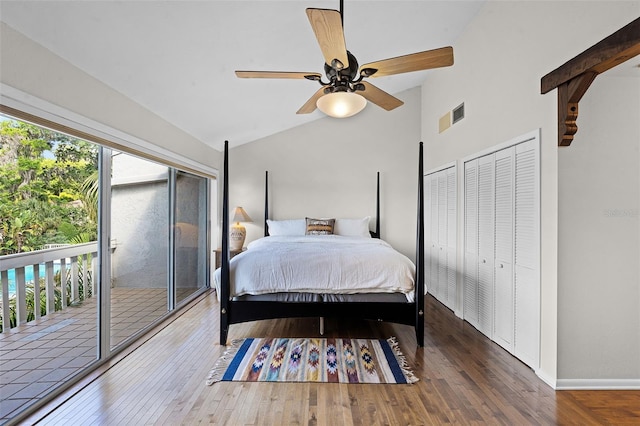 bedroom featuring wood finished floors, access to outside, multiple windows, and vaulted ceiling