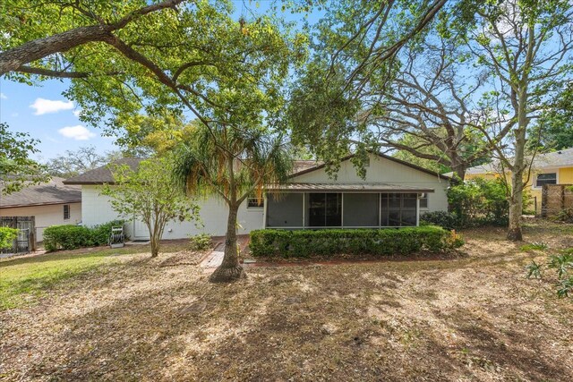 back of house featuring a sunroom and fence