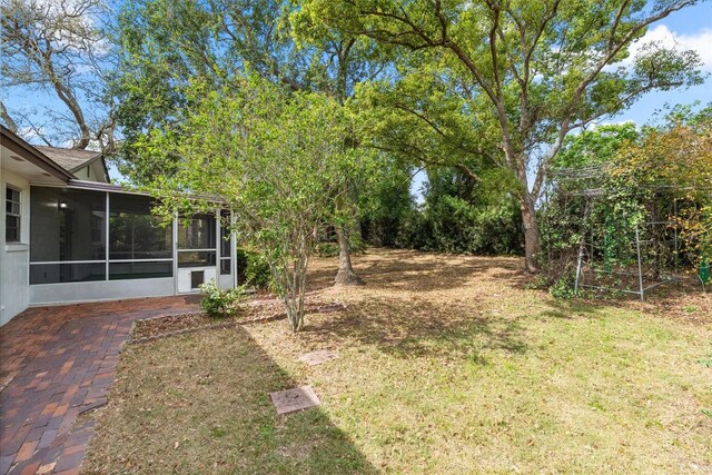 view of yard with a sunroom