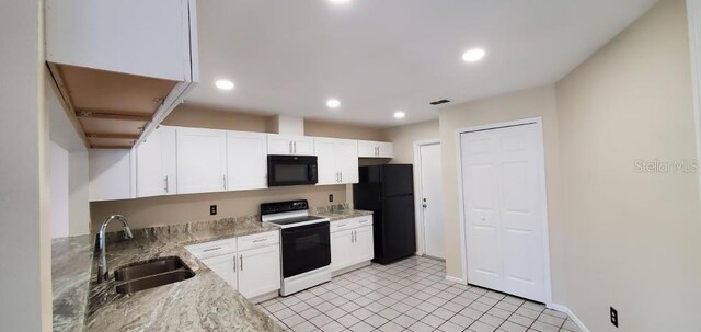 kitchen featuring black appliances, a sink, white cabinets, and recessed lighting