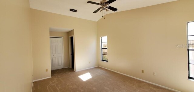 spare room with baseboards, a ceiling fan, visible vents, and carpet flooring