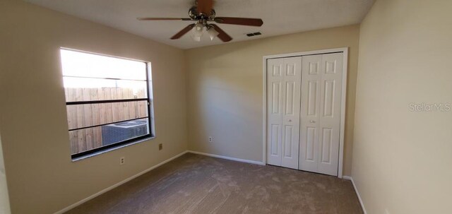 unfurnished bedroom with a closet, carpet flooring, baseboards, and visible vents
