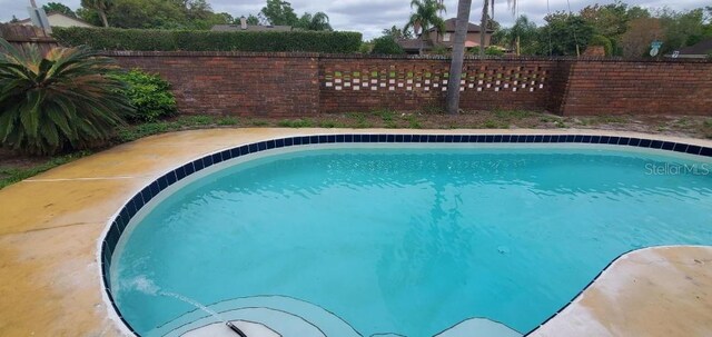 view of pool with a fenced backyard and a fenced in pool